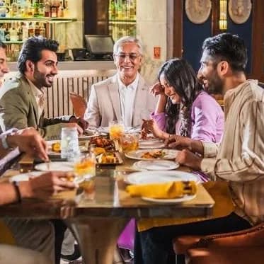 A long table dinner with people laughing together