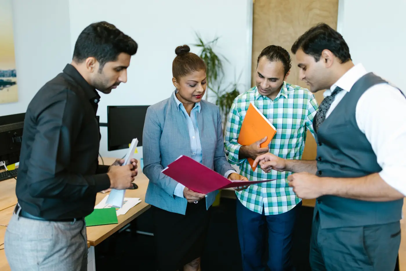 Colleagues reviewing a project requirement together in an office